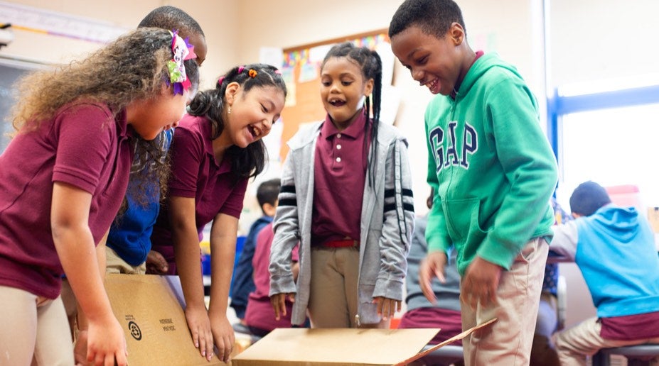 students opening a box of new resources