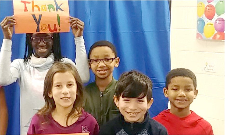 Students in front of a green screen