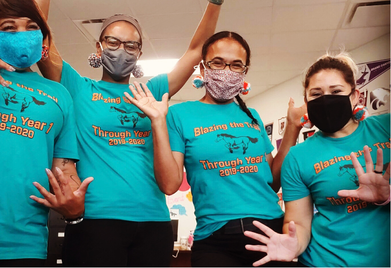 group of happy teachers wearing masks