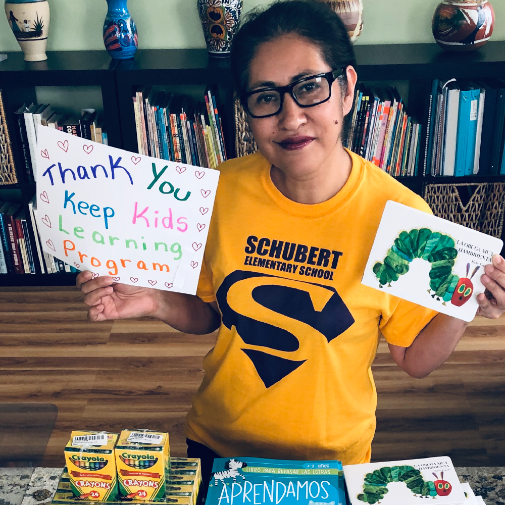 Ms. Hernandez holding books